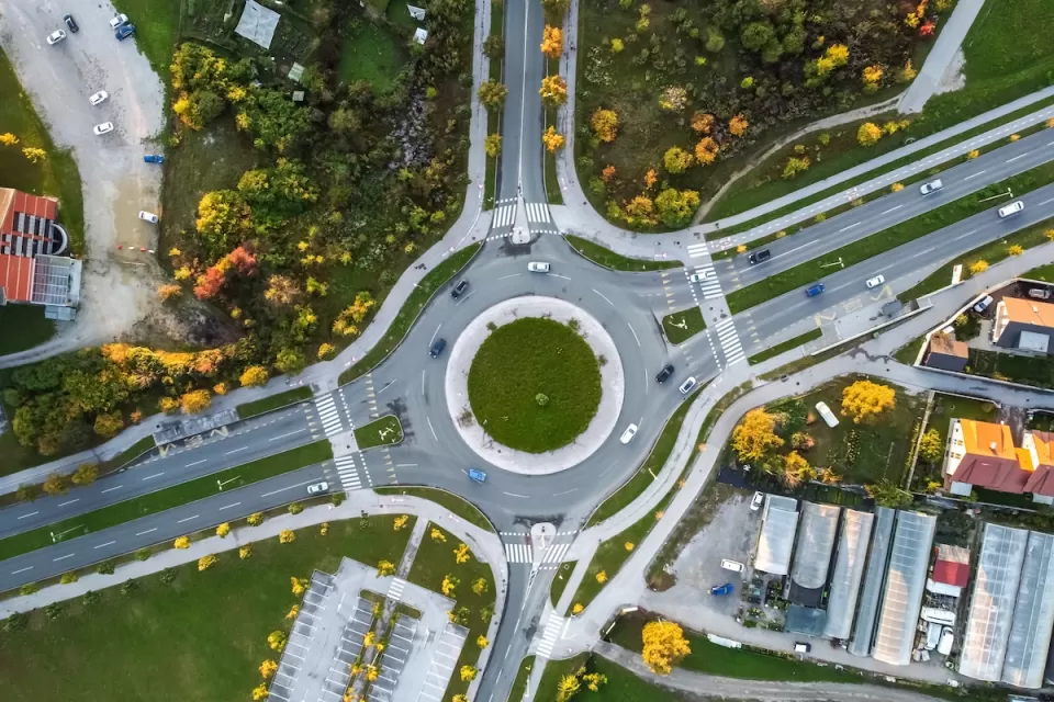 Bird's eye view of roundabout with two lanes and four branches.